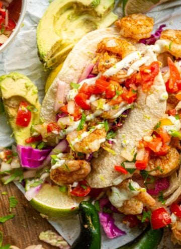 Is there anything better than grilled shrimp tacos? nope. But add a quick tangy slaw and some easy crema and it's pretty much heaven.