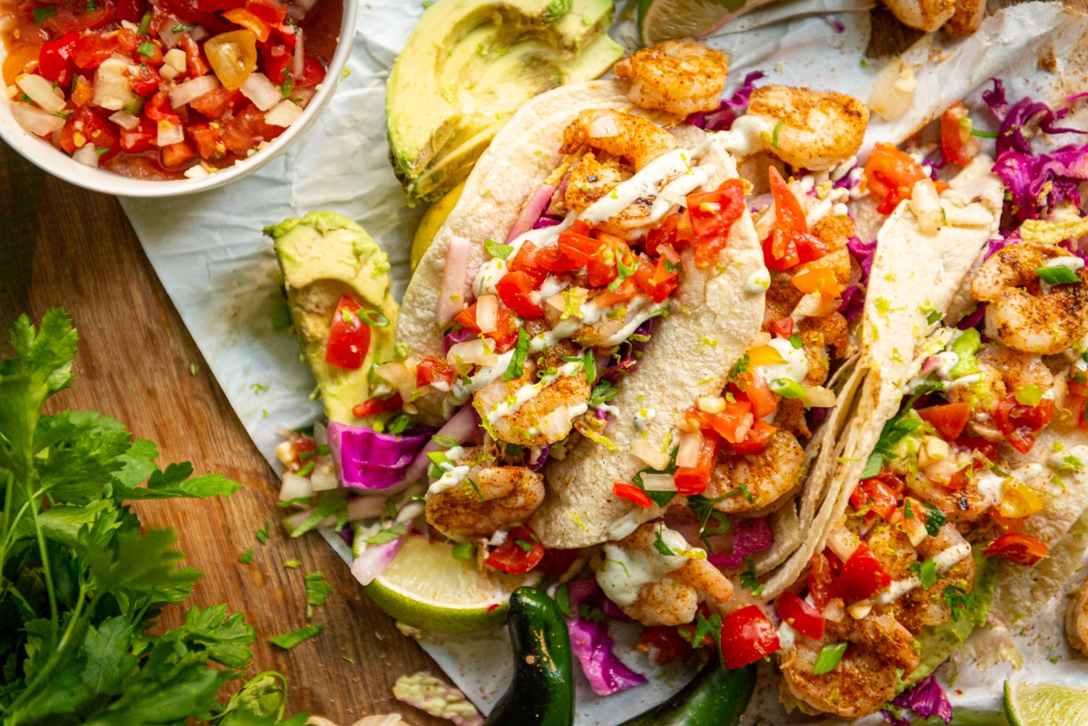 Is there anything better than grilled shrimp tacos? nope. But add a quick tangy slaw and some easy crema and it's pretty much heaven. 