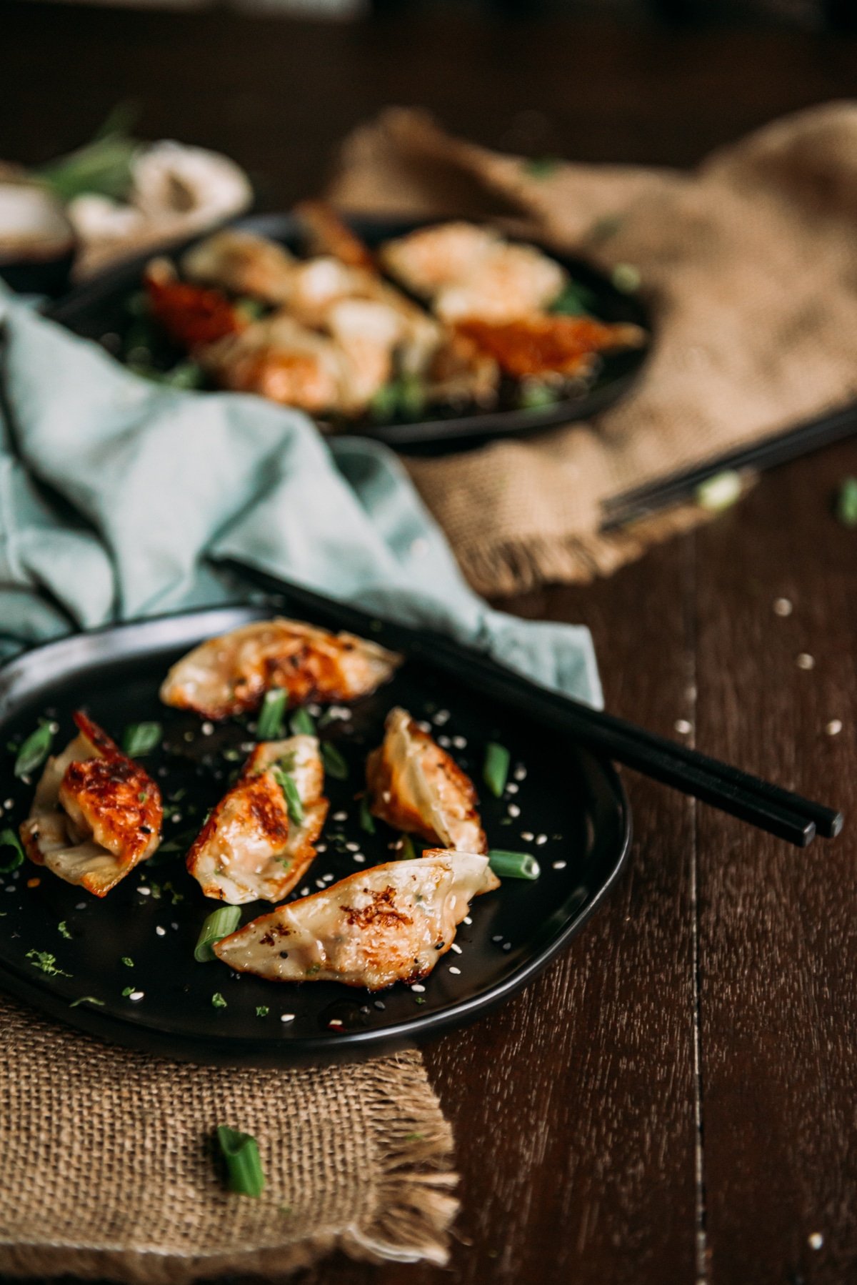 platter of salmon dumplings with chopsticks on wooden table