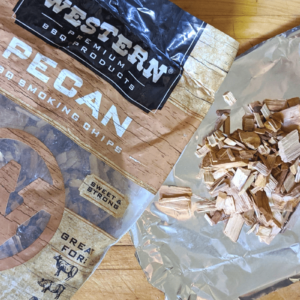 Western Wood Pecan Chips in bag and on foil sheet side by side