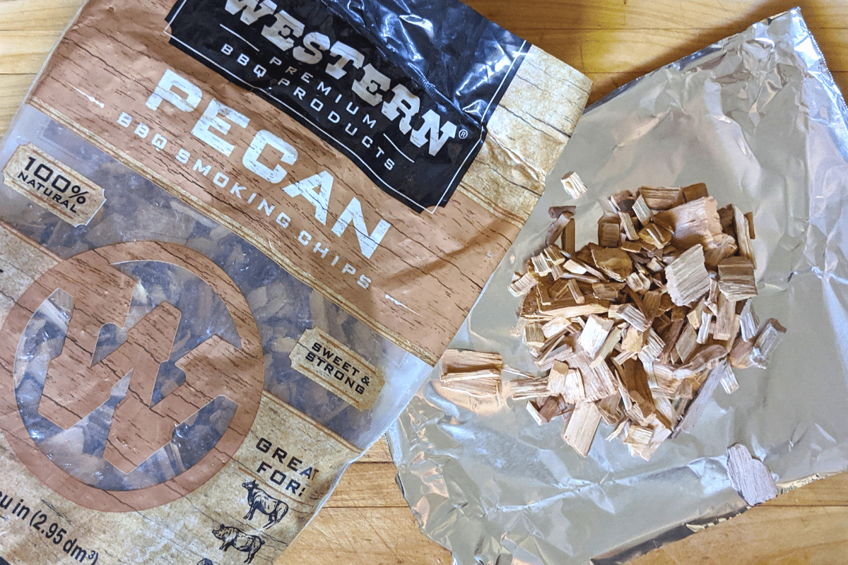 Western Wood Pecan Chips in bag and on foil sheet side by side. 