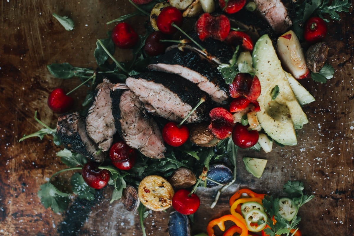 Sliced char-grilled pork tenderloin topped with stone fruit salsa