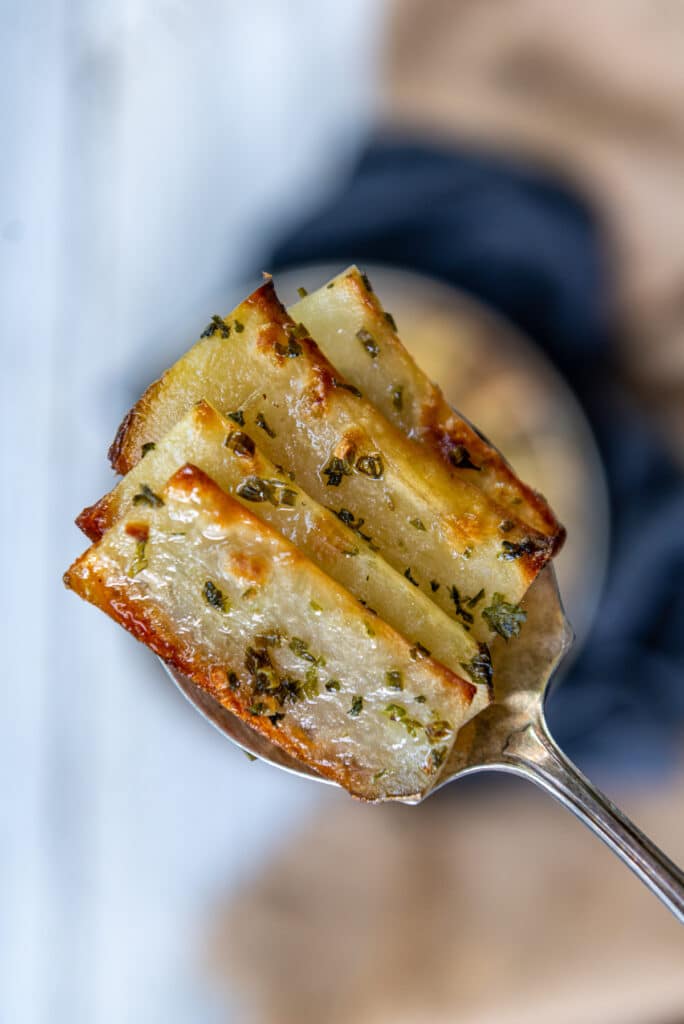 Spoonful of crispy dominoes potatoes - browned on either edge with tender centers 