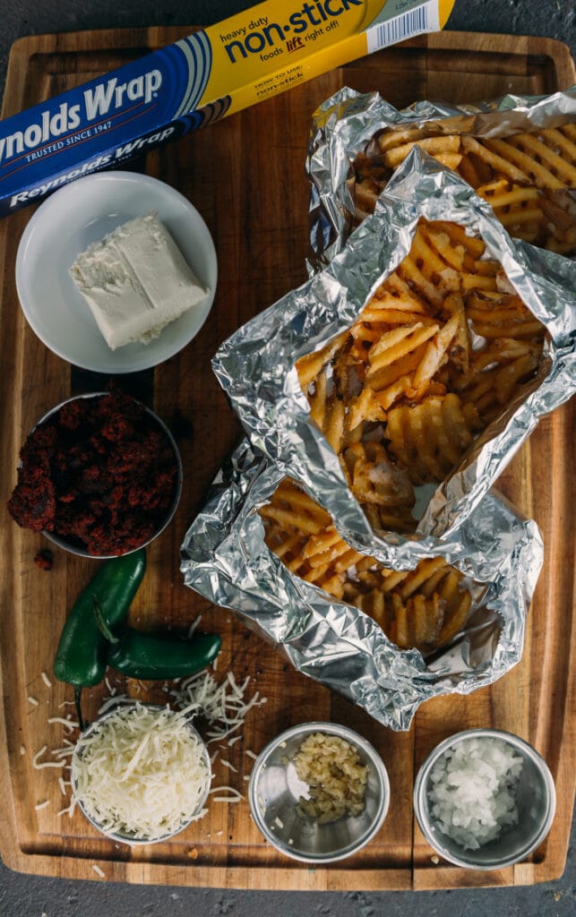 close up of waffle fries and ingredients showing waffle fries in foil packets for grilling