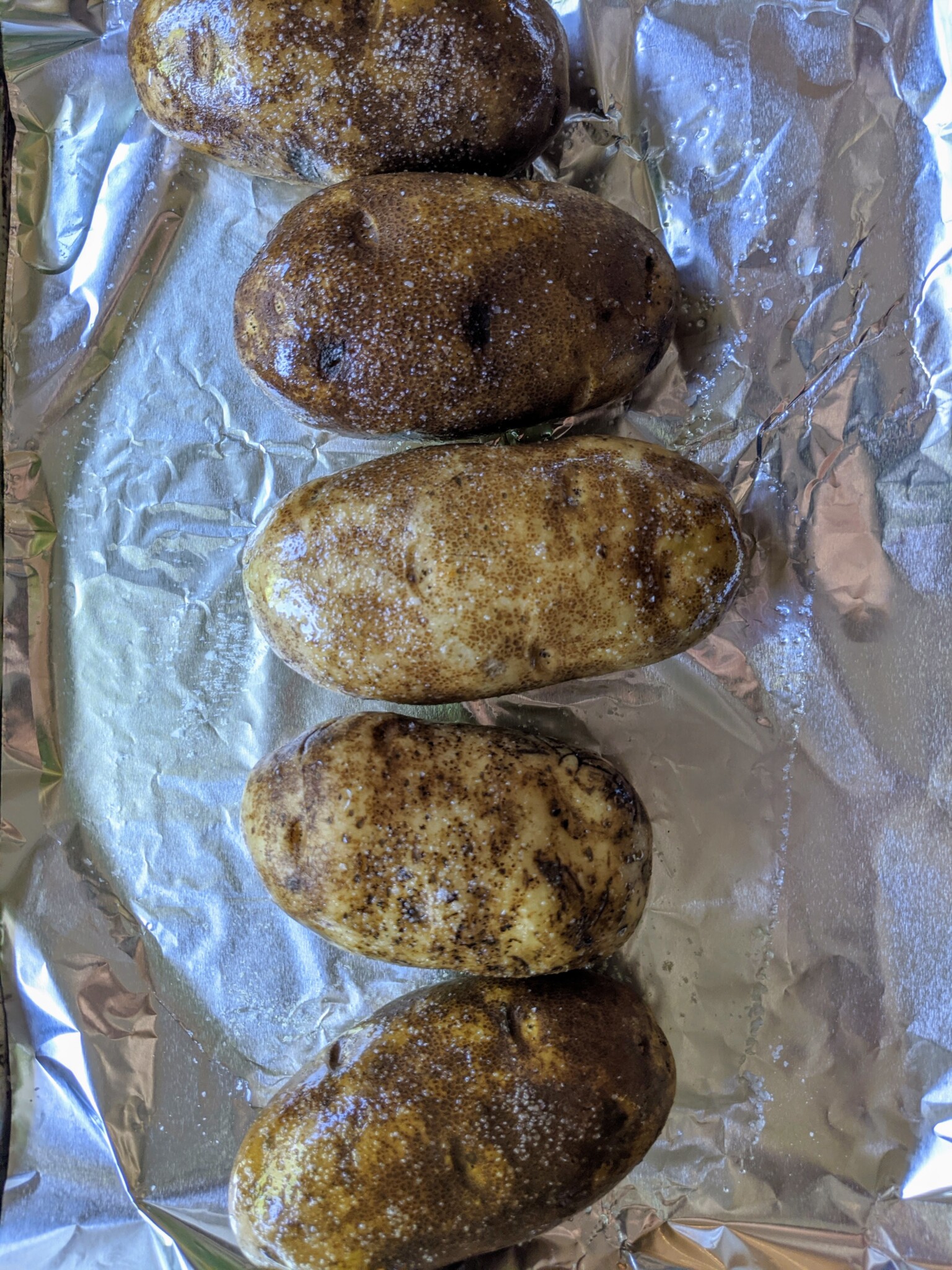 Oil rubbed russet potatoes ready to be baked 