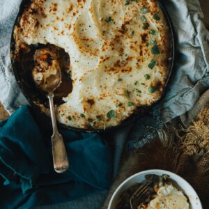 over head shot of Moroccan Sheppards Pie with a heaping portion removed from skillet