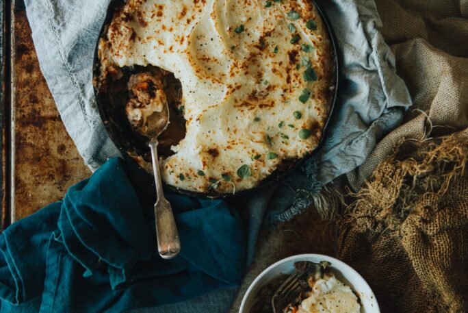 over head shot of Moroccan Sheppards Pie with a heaping portion removed from skillet