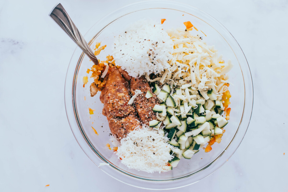 Sausage, cheese and ingredients for slow cooker stuffed peppers in bowl