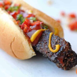 An epic hot dog with ketchup and mustard on it.
