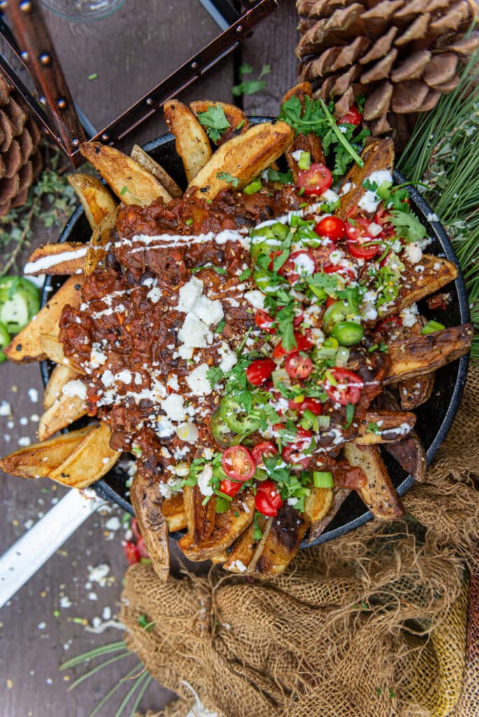 Camp stove fried fries smothered in leftover pulled pork dutch oven chili with all the toppings