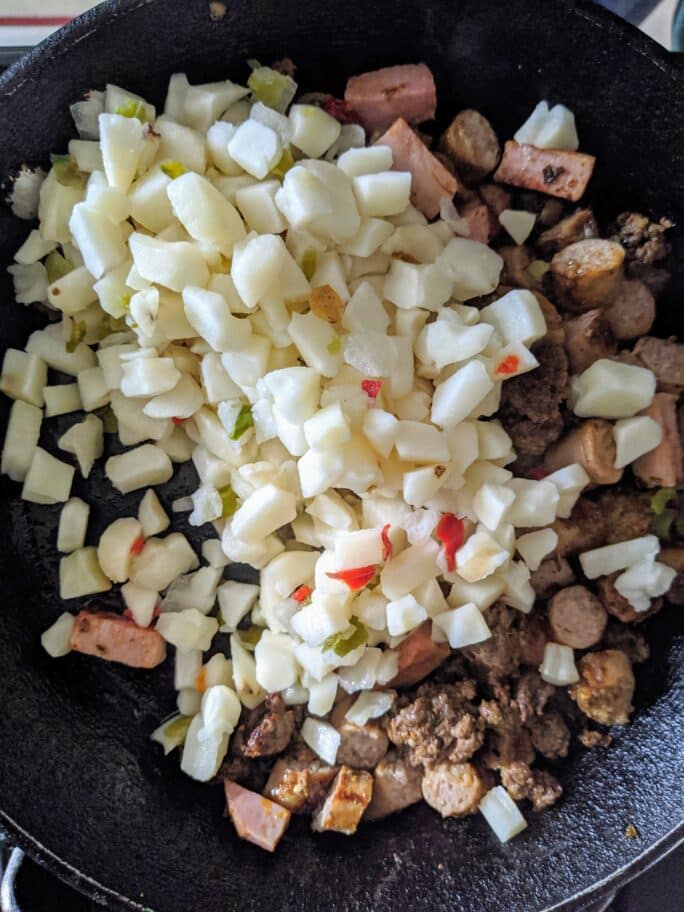 Potatoes and meat in the skillet. 
