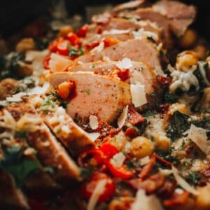 Close up of sliced pork tenderloin in skillet with gnocchi