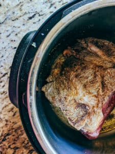 chuck roast in insta-pot showing browned sides