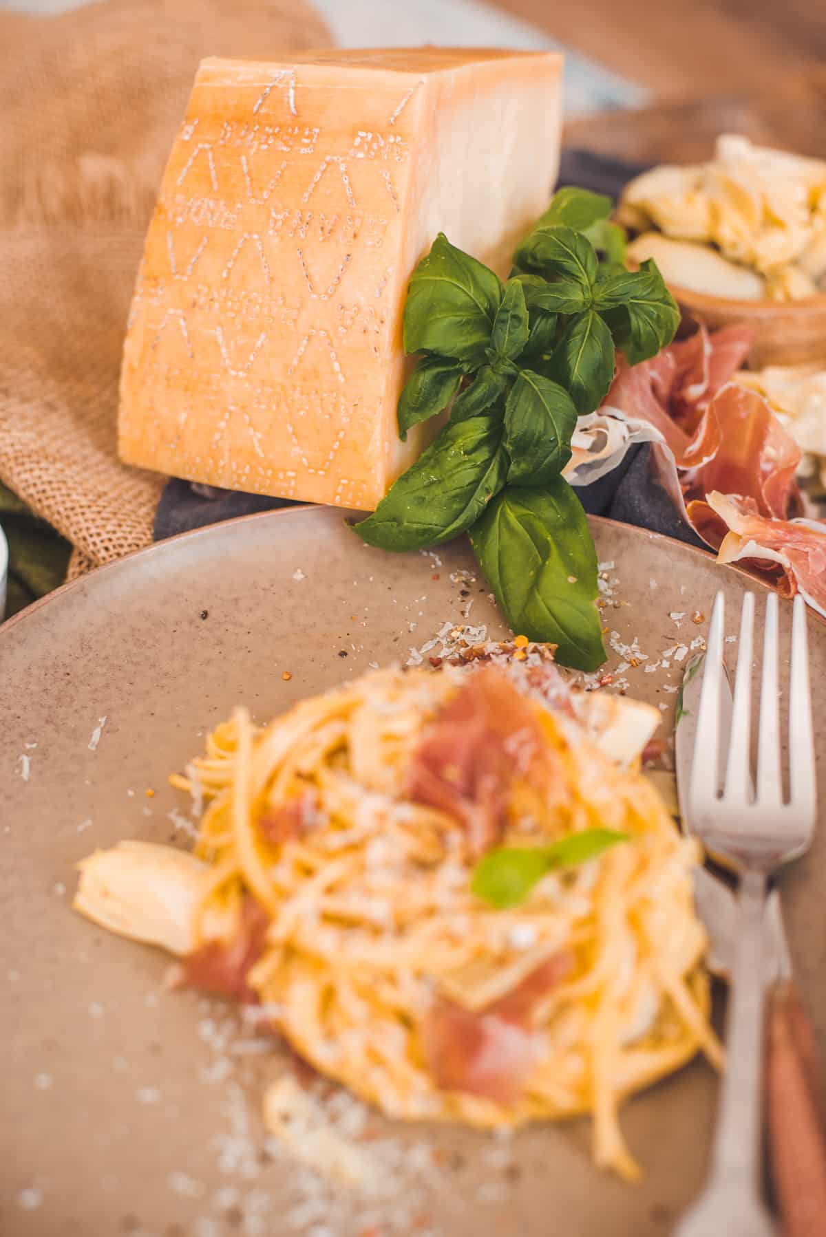 Serviced Carbonara and Grana Padano Cheese in a Table