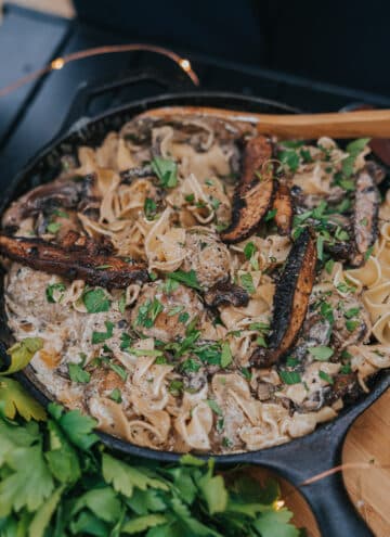 Cast iron pan filled with creamy meatball stroganoff and portabella mushrooms