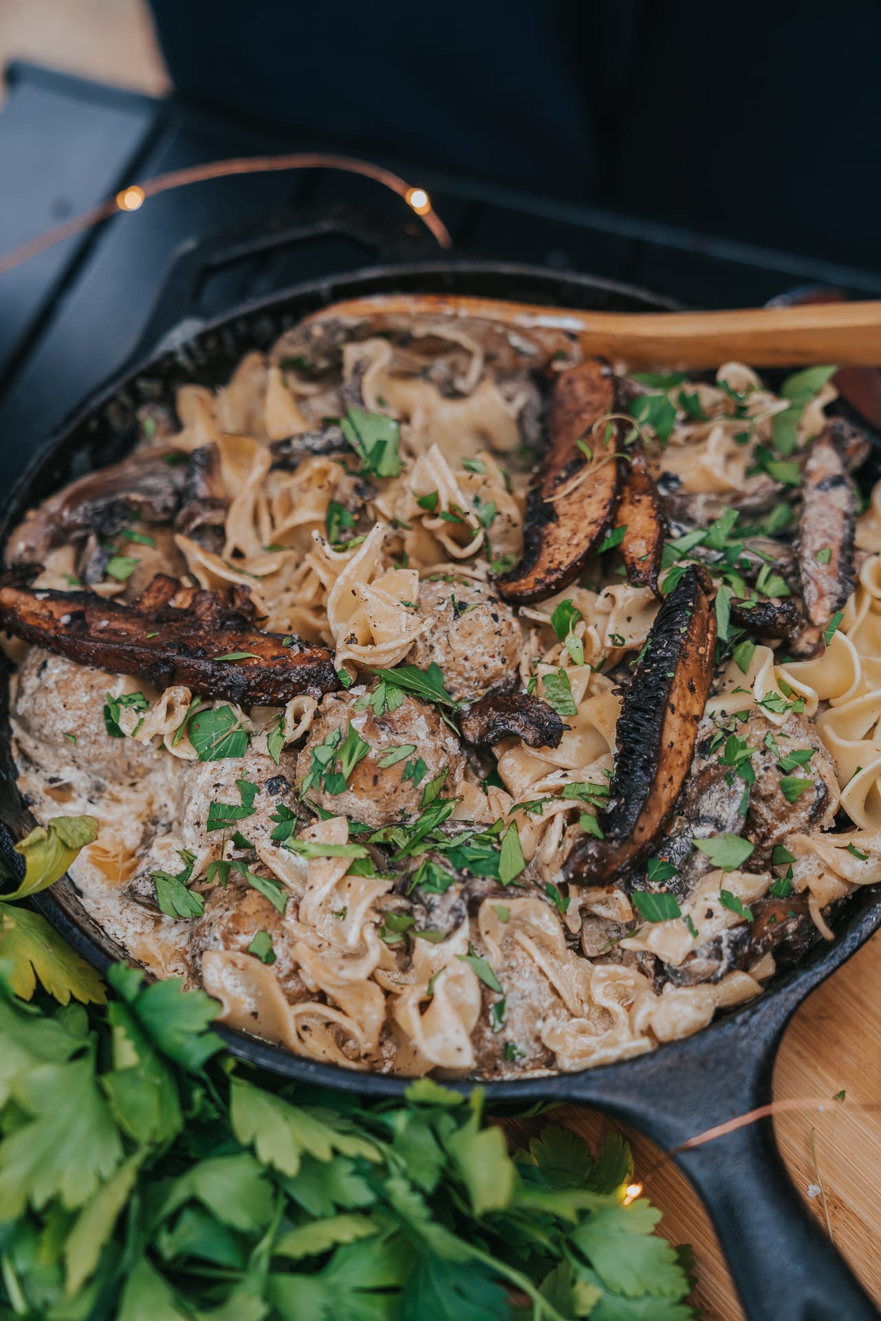 Cast iron pan filled with creamy meatball stroganoff and portabella mushrooms
