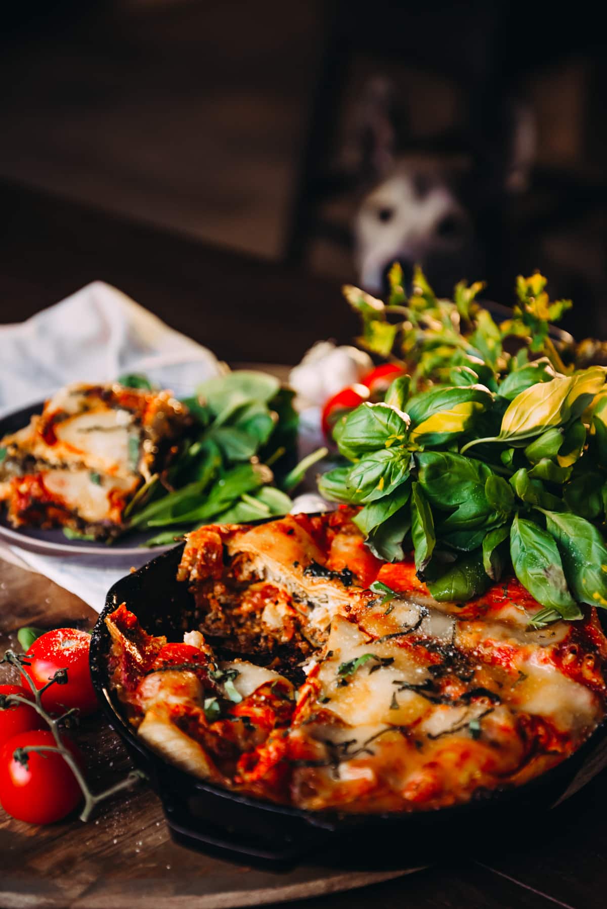 Freshly made Lasagna in Skillet with herbs and cherry tomatoes