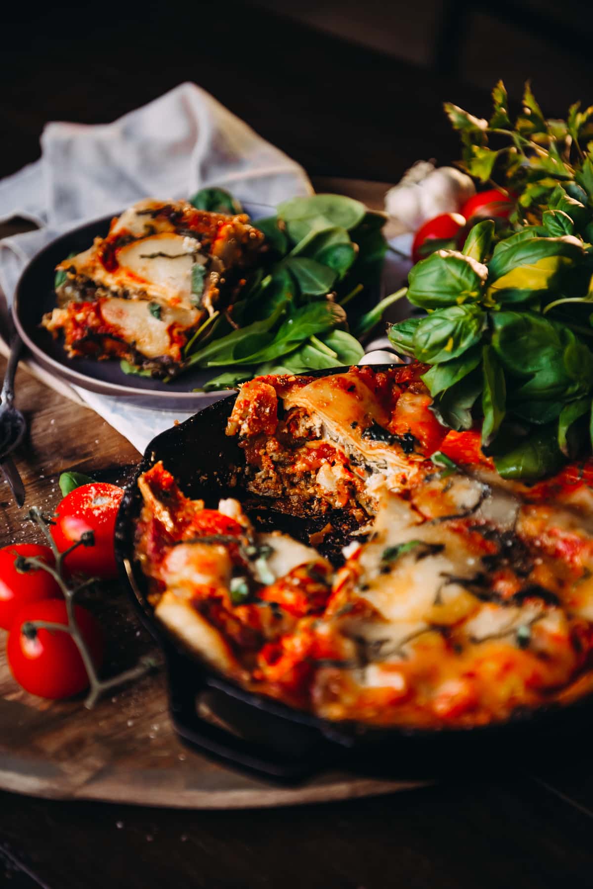 showing the skillet of lasagna with a slice removed