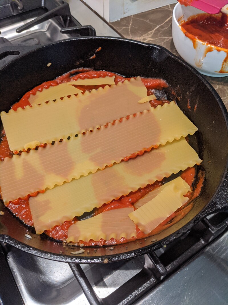 Showing the no boil pasta arranged in the skillet for the lasagna