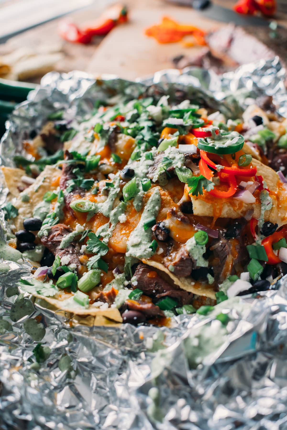 Garnishing Delicious, Cheesy, Meaty Carne Asada Campfire Nachos