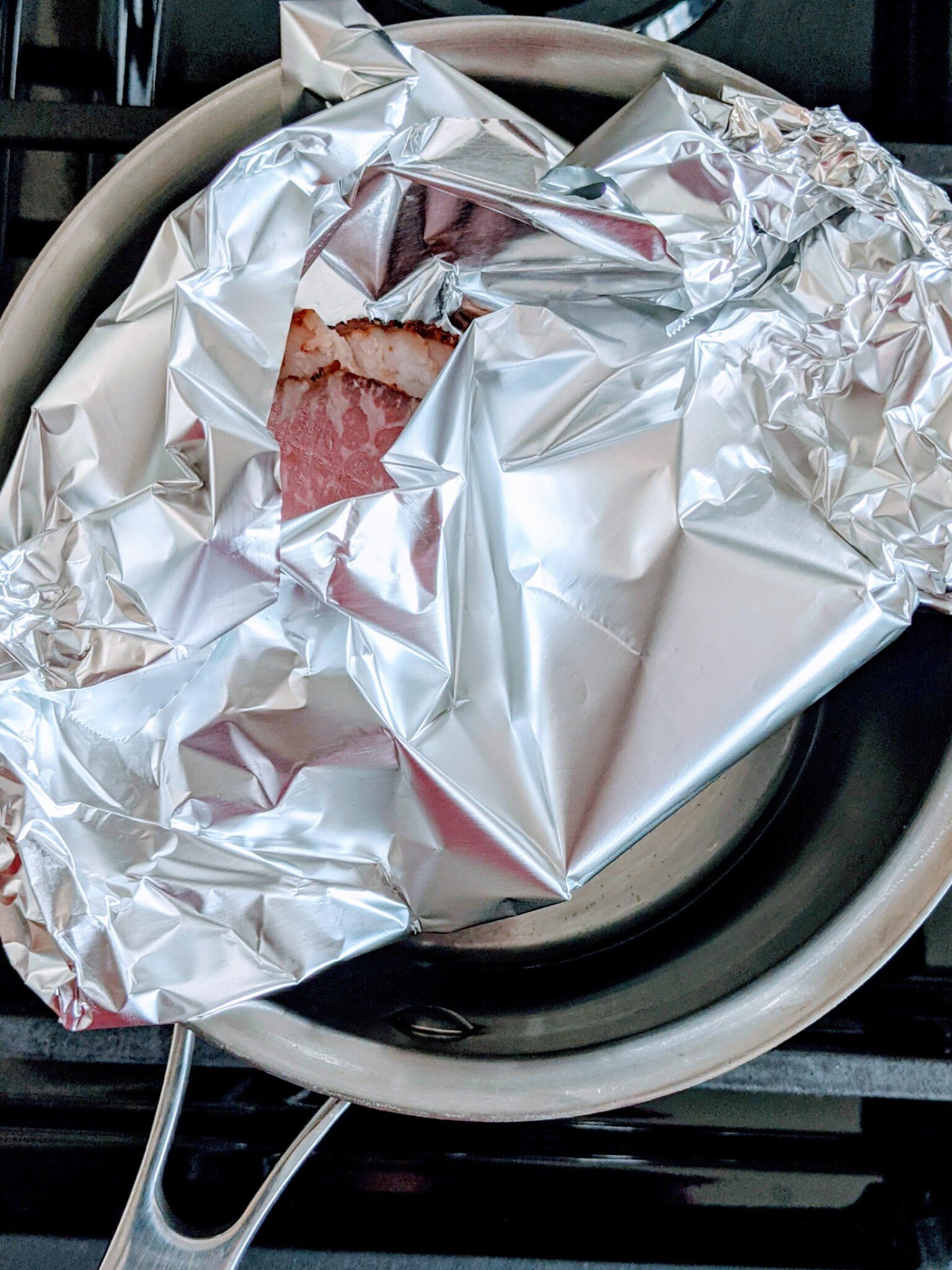 showing how to steam slices of pastrami to heat and serve in a pot using foil to elevate and protect the meat