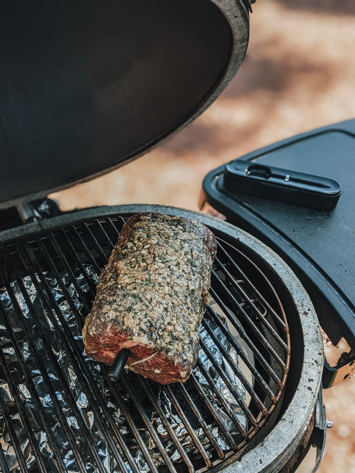 round roast coasted in herbs on grill