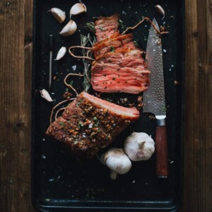 above shot of char-grilled roast beef sliced on board for presentation