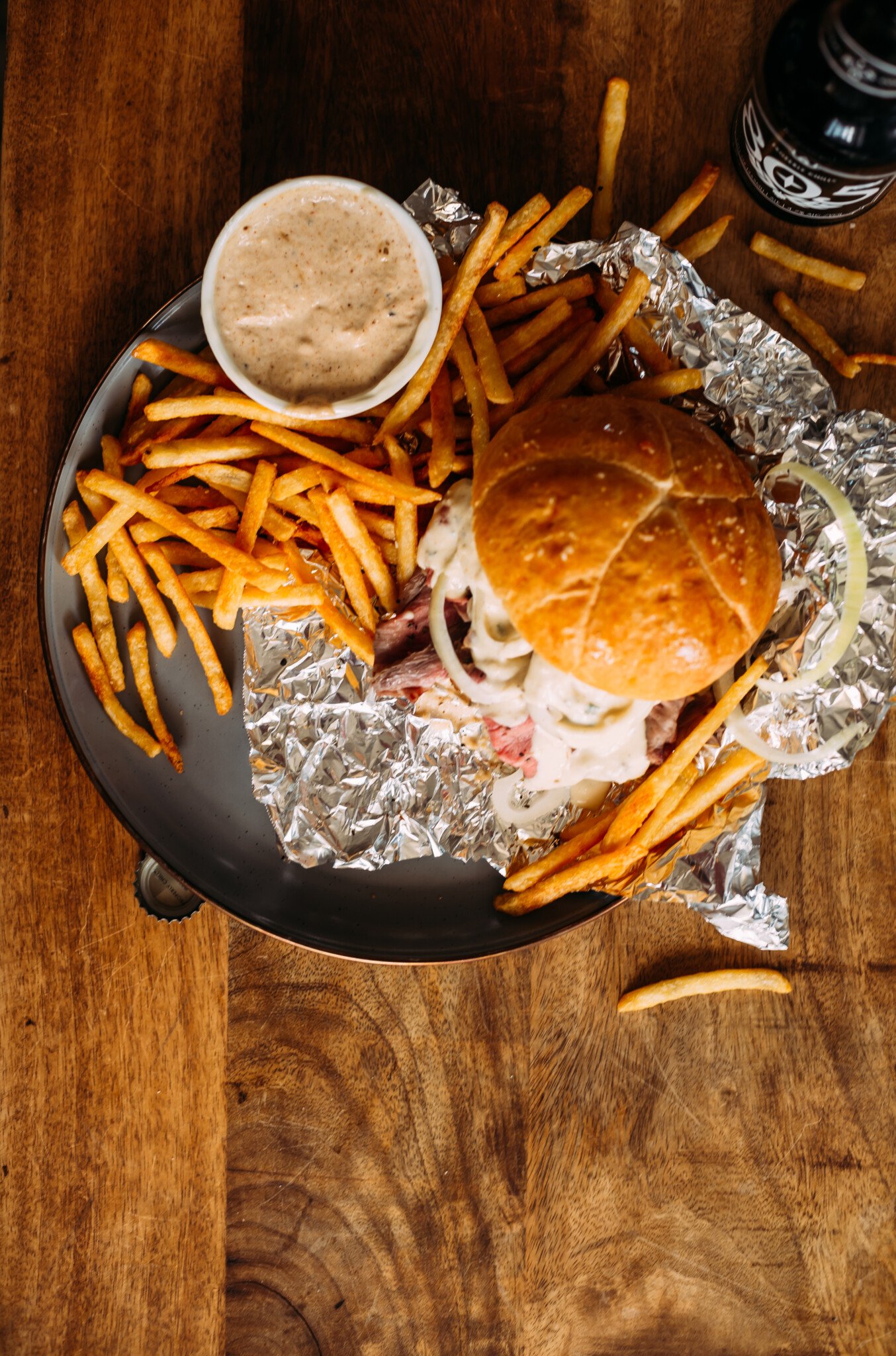 Soft Bun Smokey Pit Beef Sandwich severed with Fries and Dip