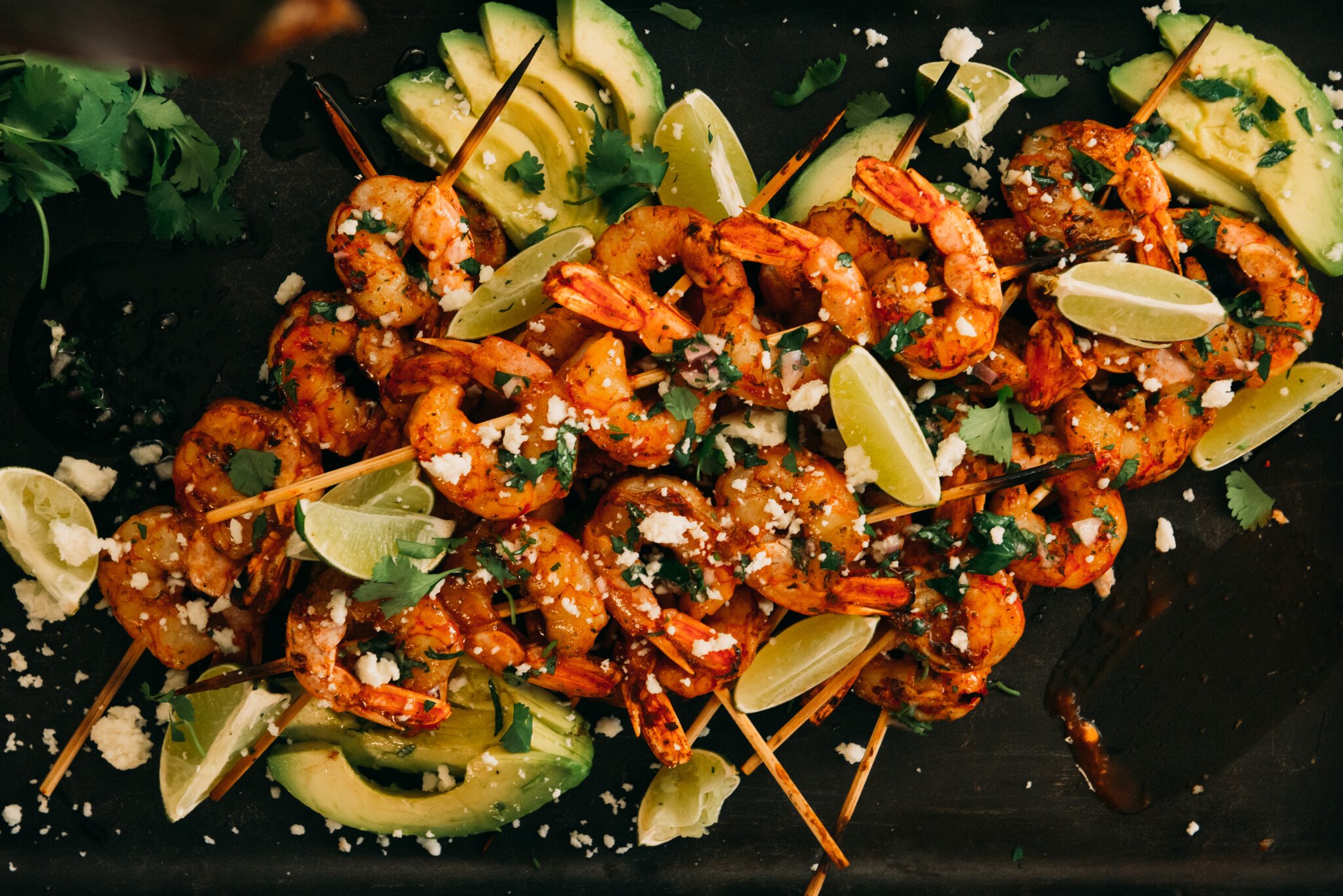 Barbecue shrimp Skewers garnished with lime and cilantro