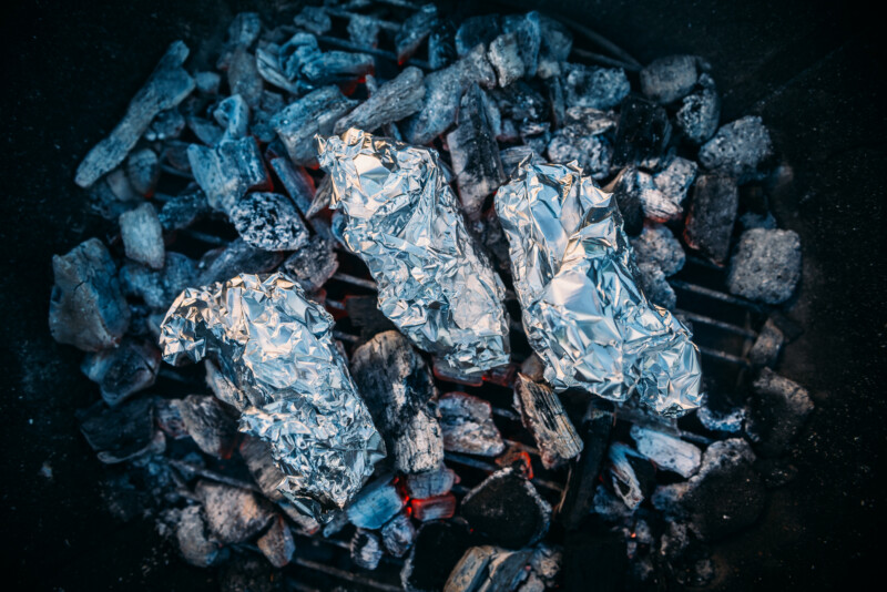 foil wrapped baked potatoes directly on coals