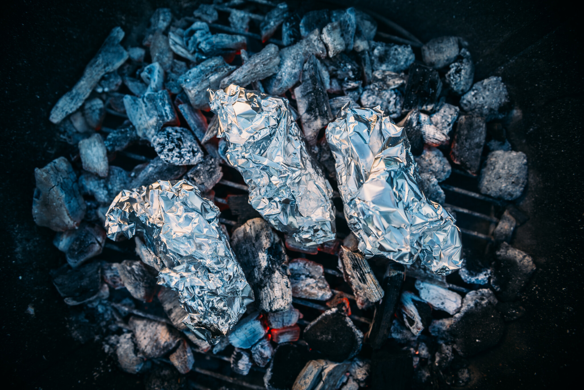 Campfire baked potatoes in coals. 