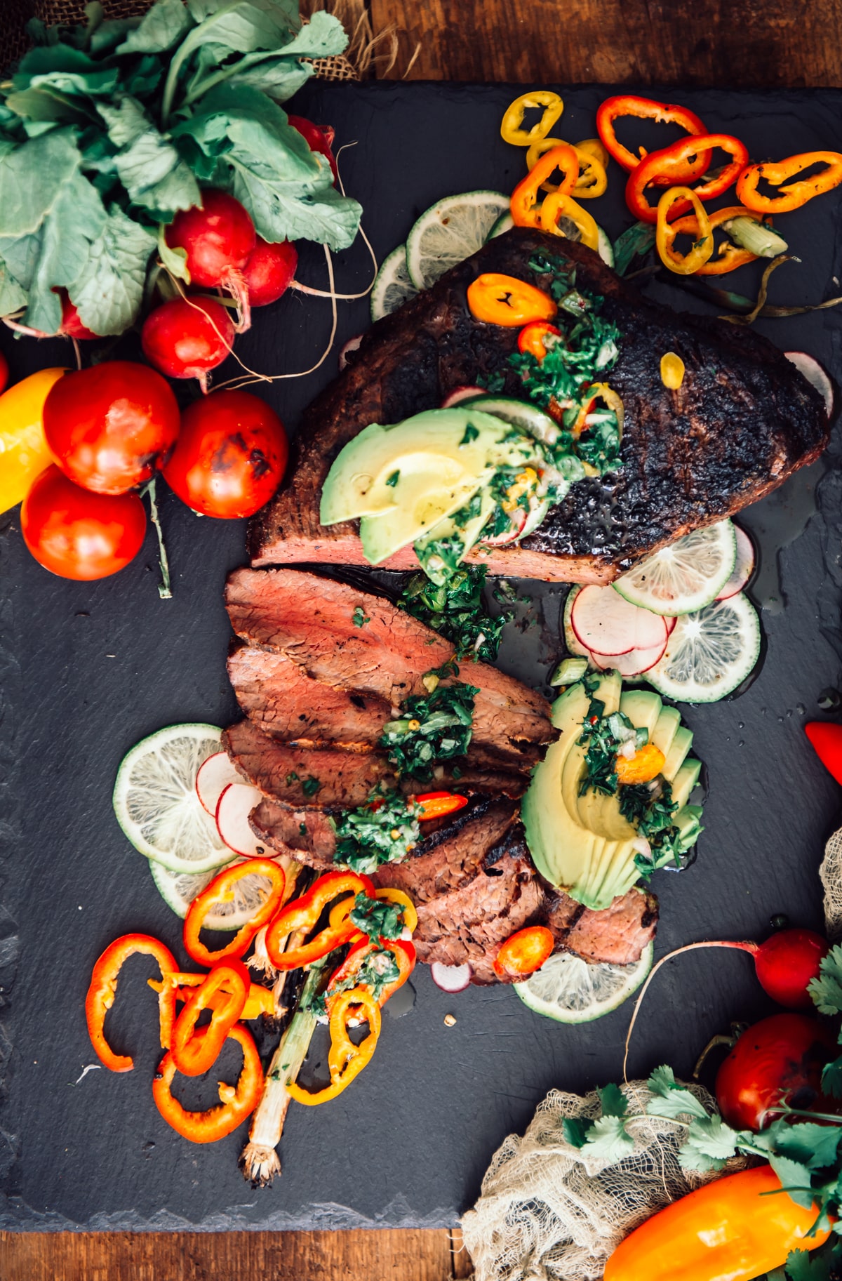 sliced trip tip topped with chimichurri and avocado.