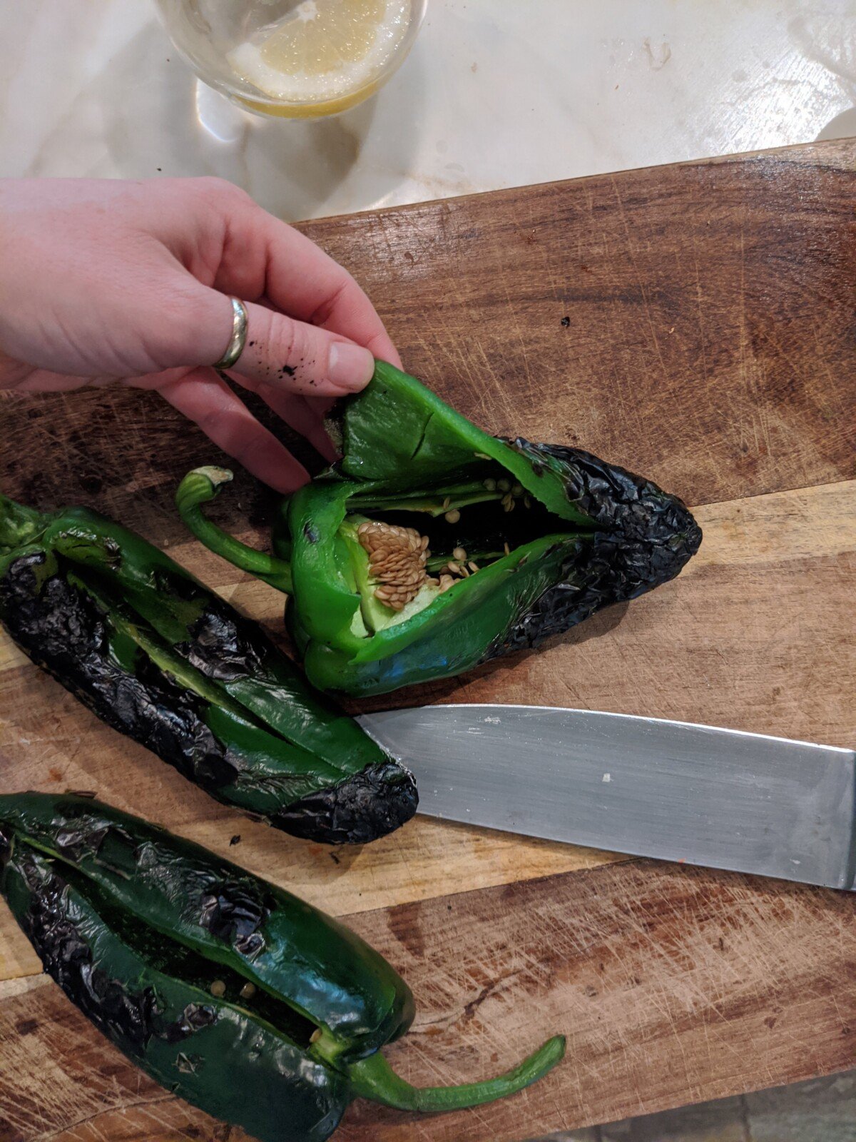 showing roasted poblano open to remove seeds