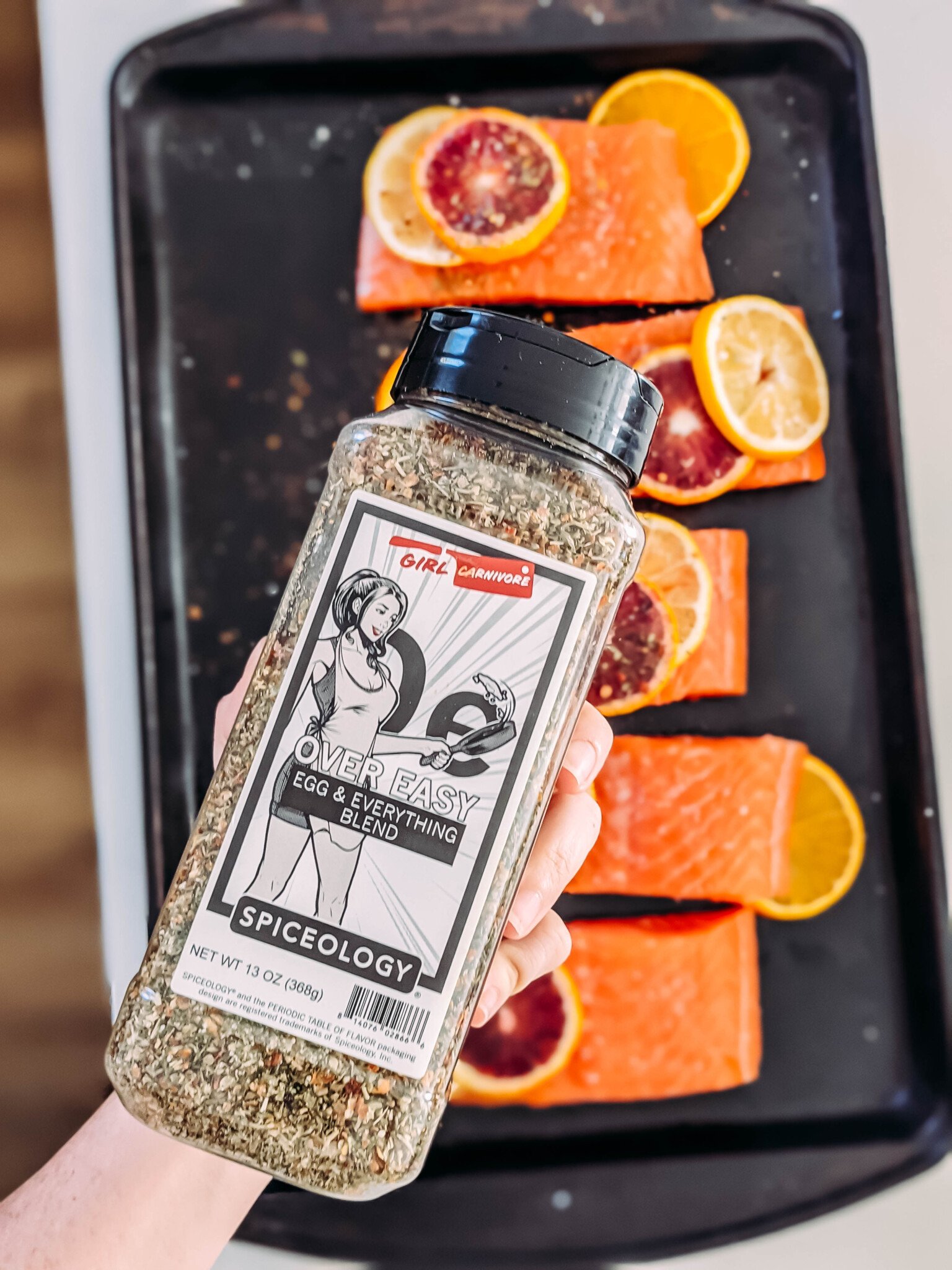 over easy spice blend over raw salmon - showing bottle