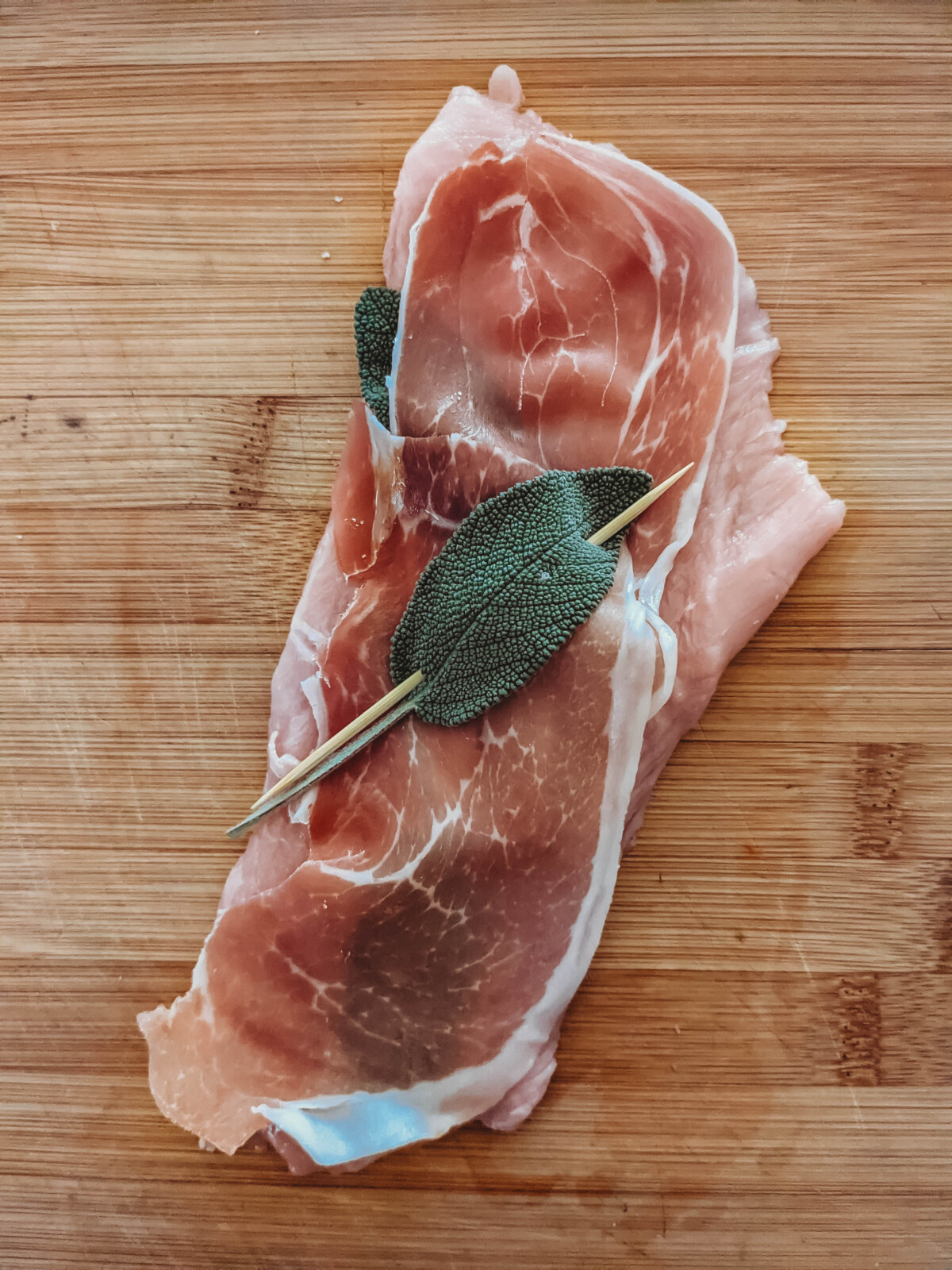 veal cutlet lined with prosciutto and sage secured with toothpick