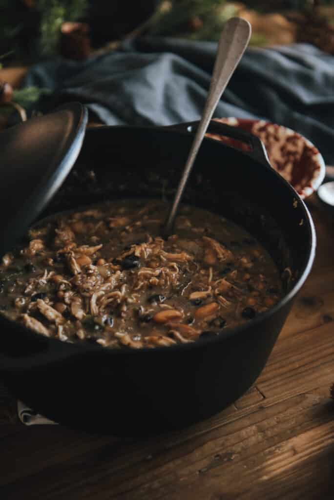 Dutch oven with shredded chicken returned to pot for white chicken chili recipe 