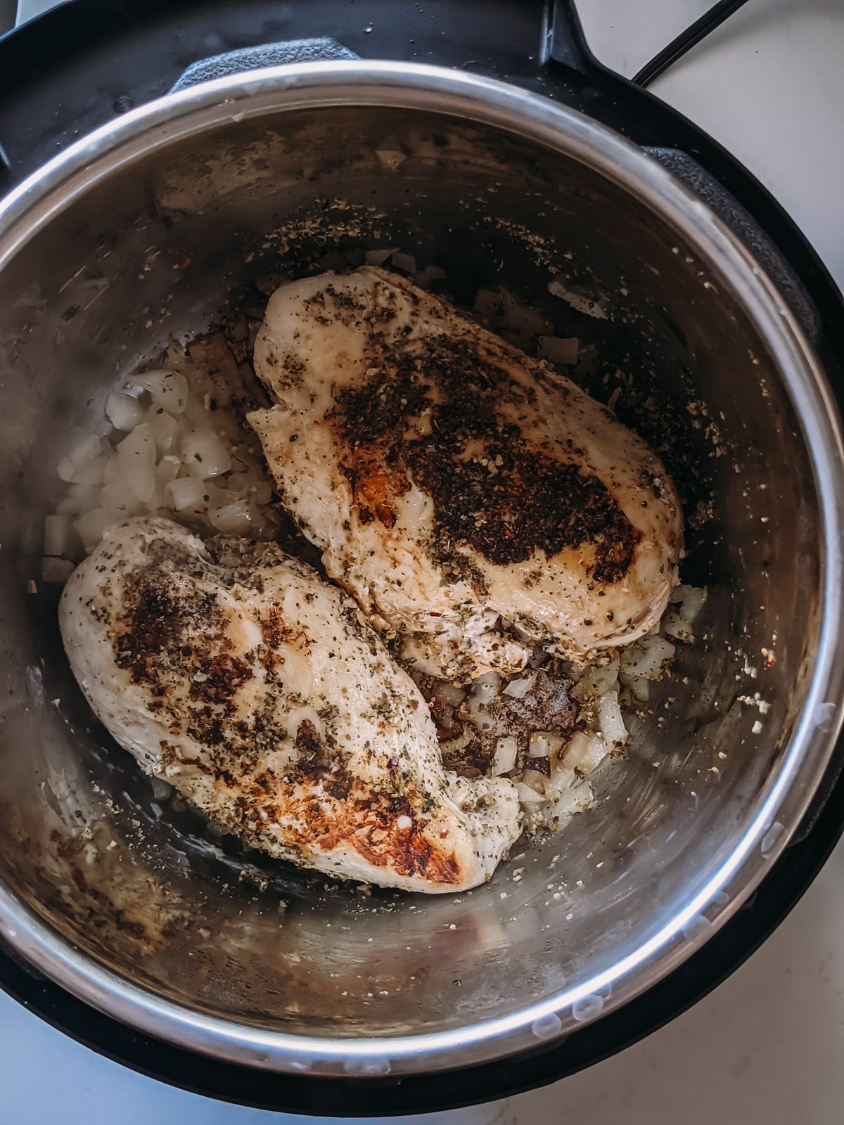 chicken browned on both sides ready to be pressure cooked in instant pot