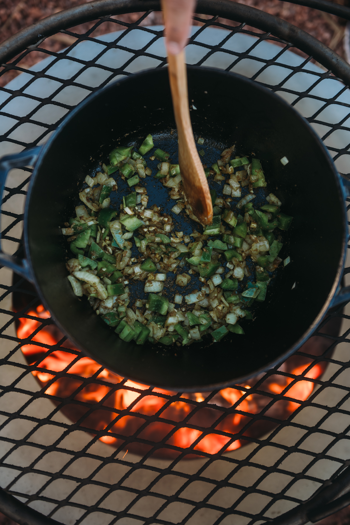 stirring bell pepper to mix in dutch oven