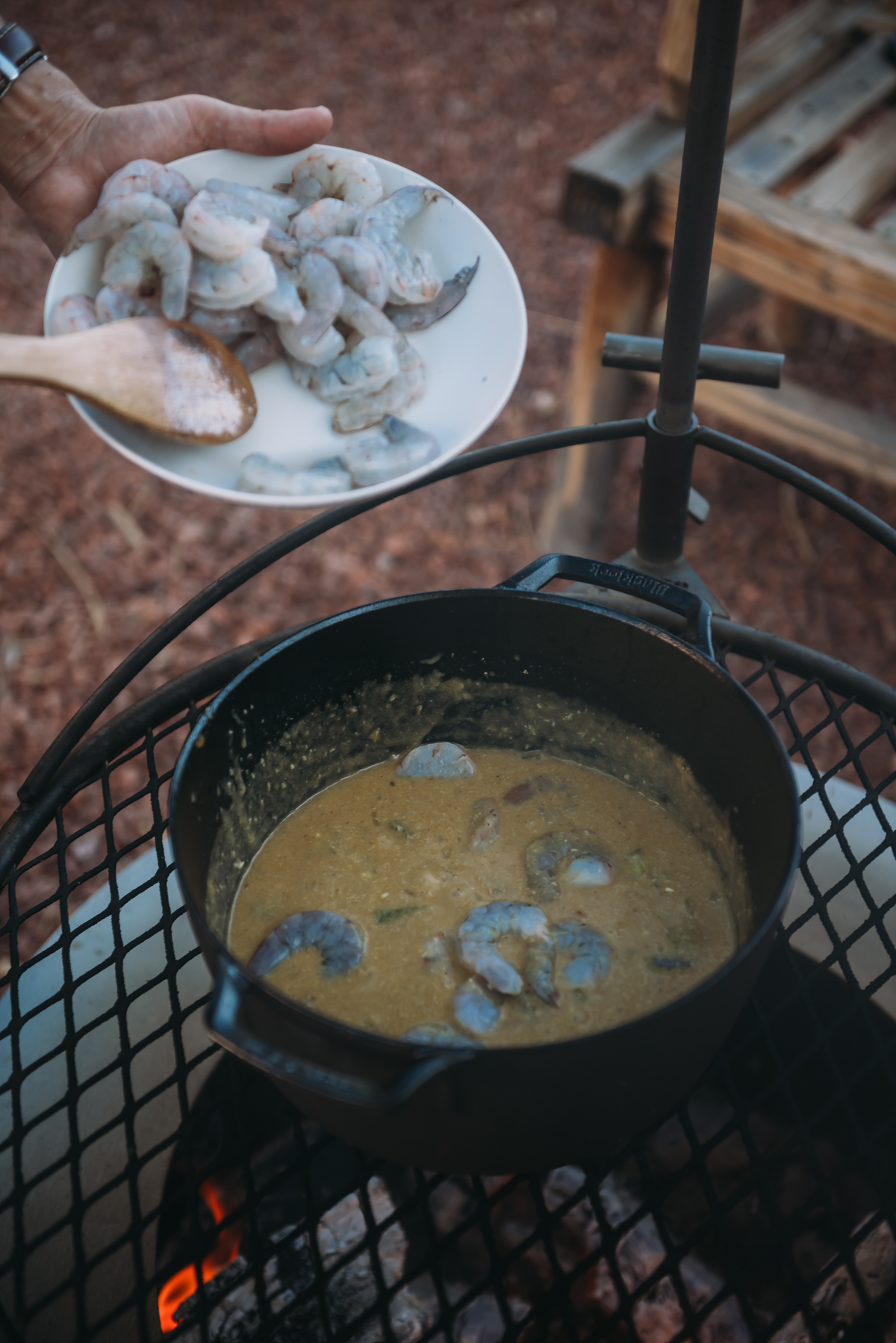 adding shrimp to the dutch oven for korma