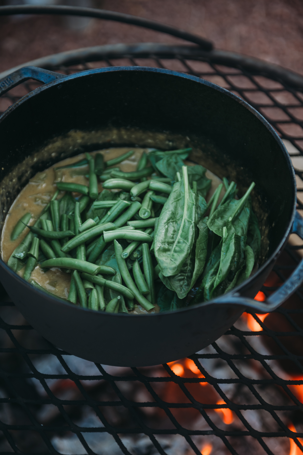 adding green beans and spinach to korma