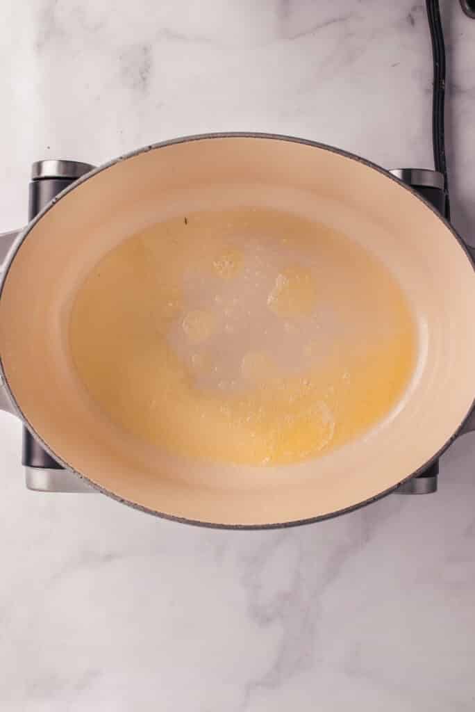 large dutch oven with melted butter