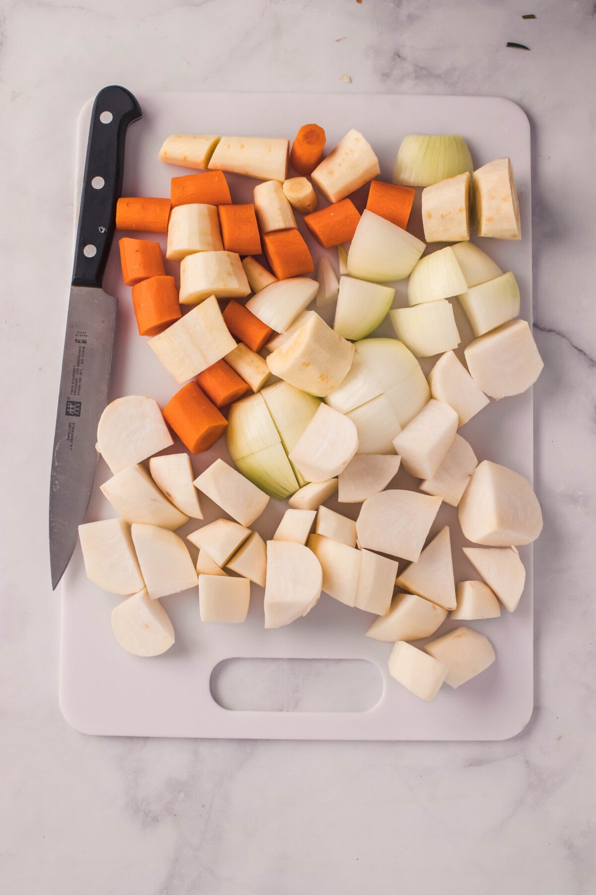 veggies being roughly chopped on cutting board
