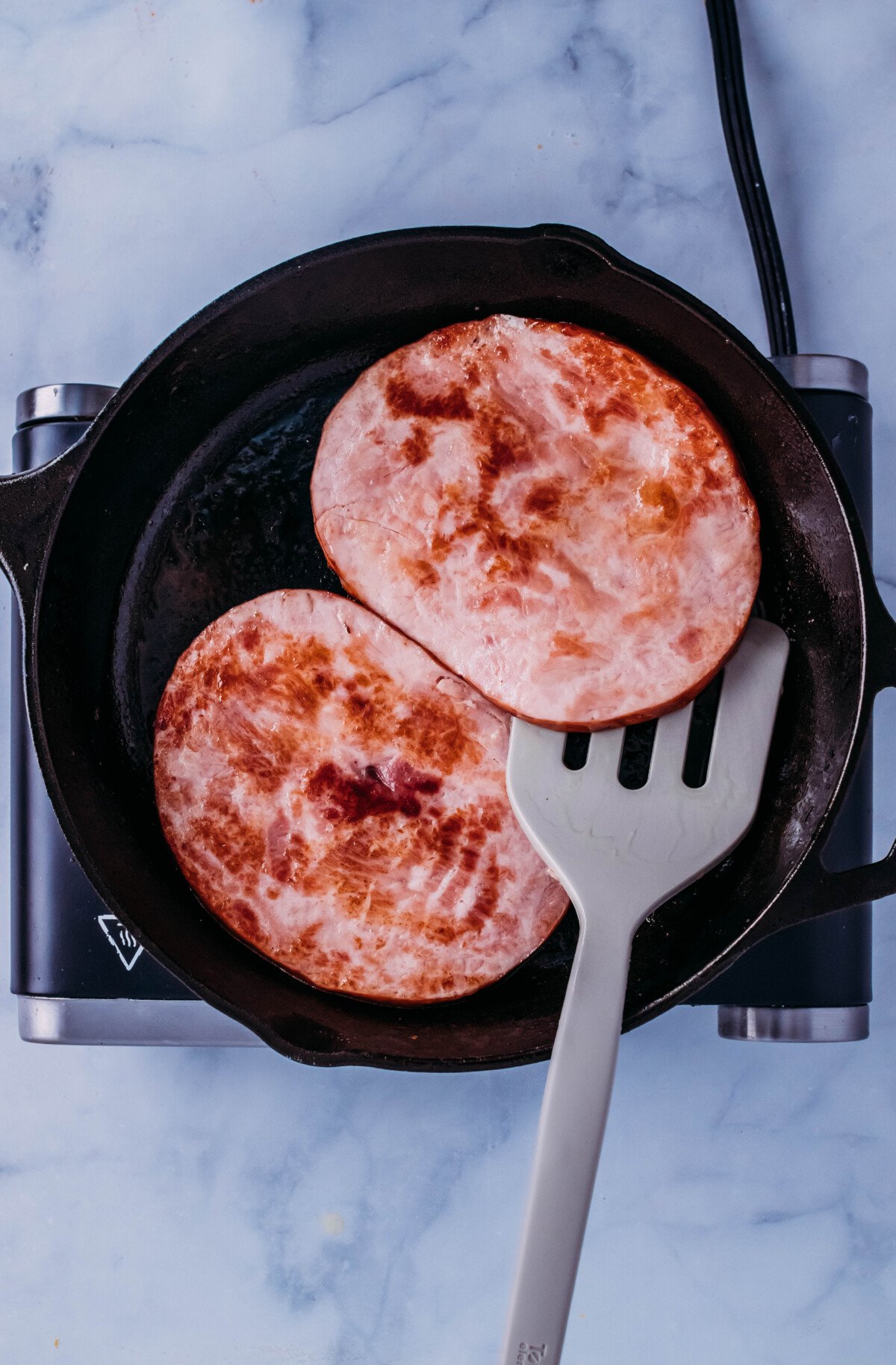 ham steaks seared in cast iron pan.