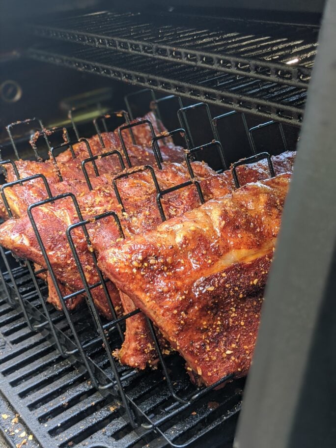 Ribs in racks on a masterbuilt gravity smoker. 