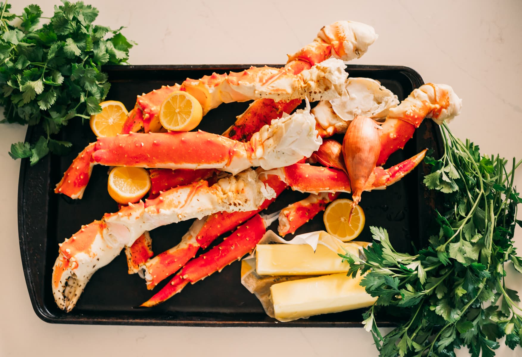 Ingredients for buttery grilled crab on a tray.