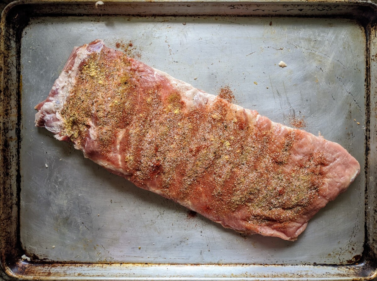 Seasonings sprinkled heavily over spare ribs.