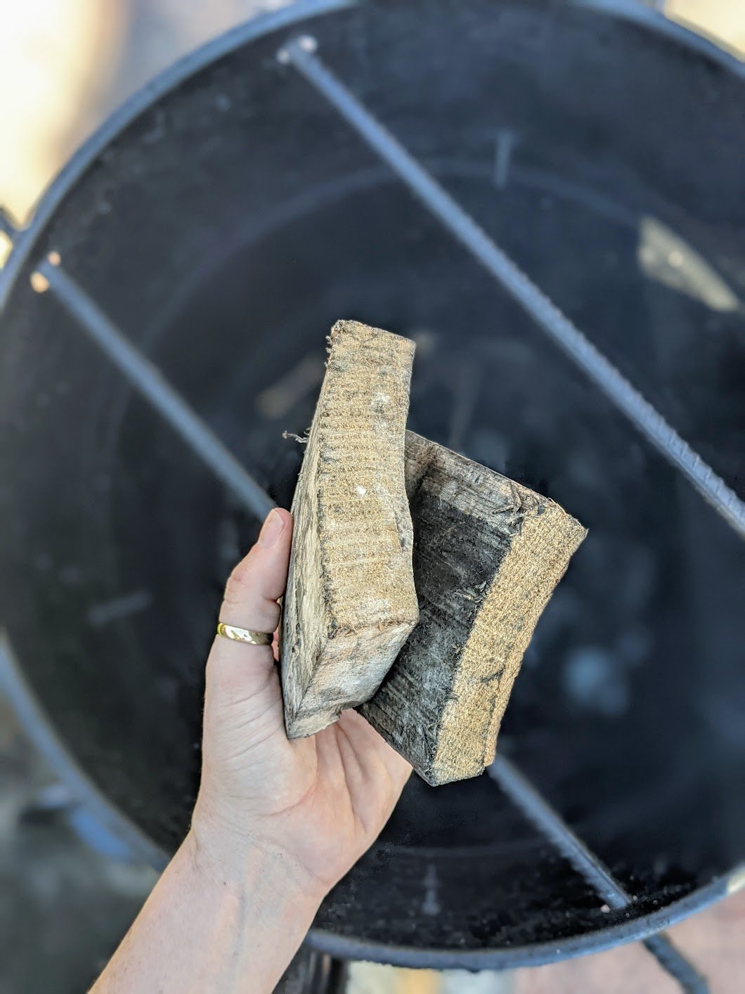 Jack Daniel's barrel chunks held above grill. 