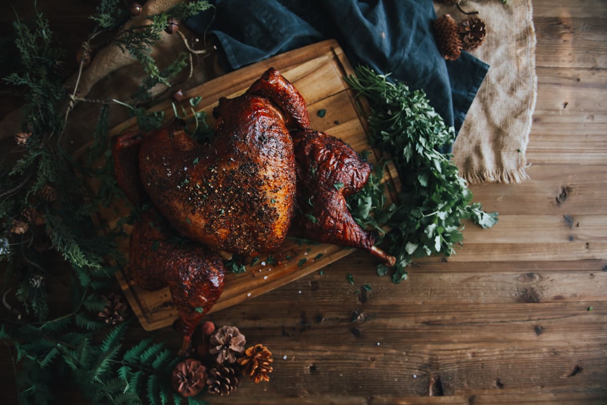 Spatchcocked turkey on a rustic table. 