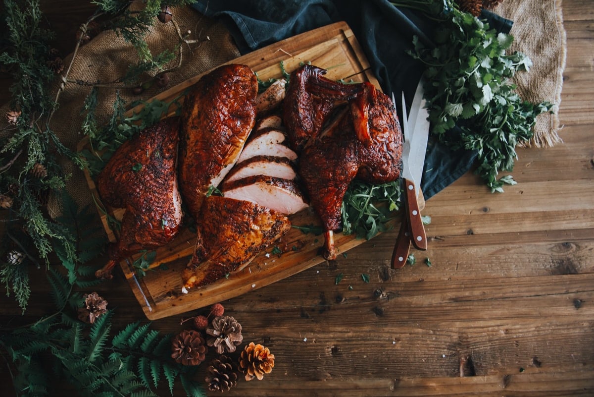 Carved smoked turkey on a cutting board. 