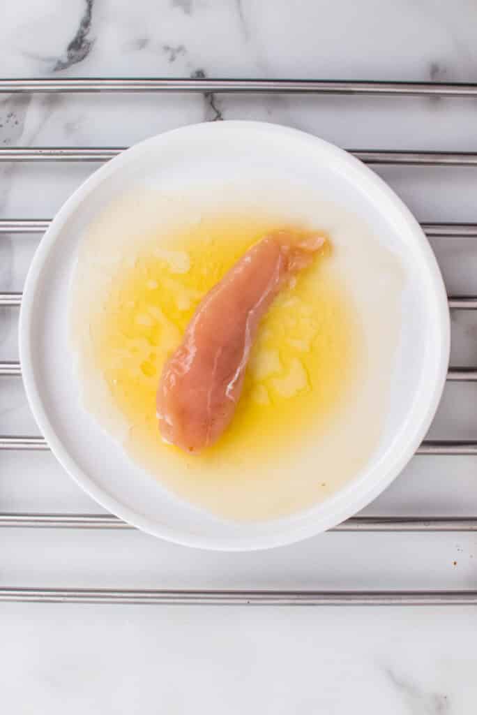 raw chicken in egg wash